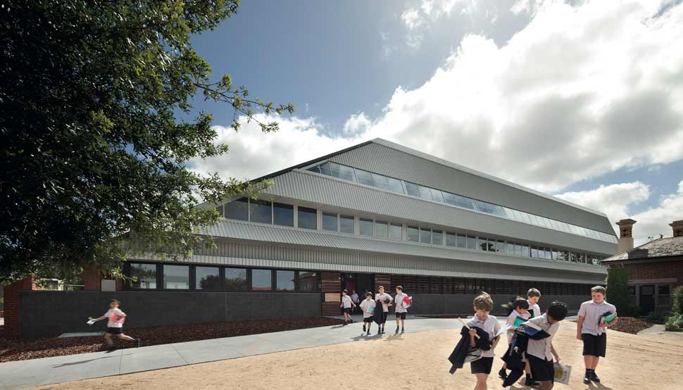 Penleigh and Essendon Grammar School (PEGS), western façade conjures up multiple references: the students have nicknamed it ‘Starship Enterprise’ because of the sci-fi appearance of the striped steel roof, which diagonally slices the extruded form. 