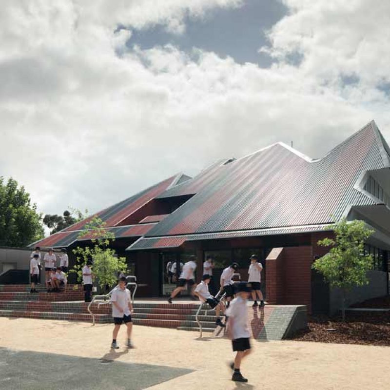 The SPANDEK® roof made from COLORBOND® steel in the colours Headland® and Monument® also nods to the home of the Essendon Football Club across the road, and creates a circus-marquee-meets-federation-grandstand aesthetic that is an ideal backdrop for a children’s playground.