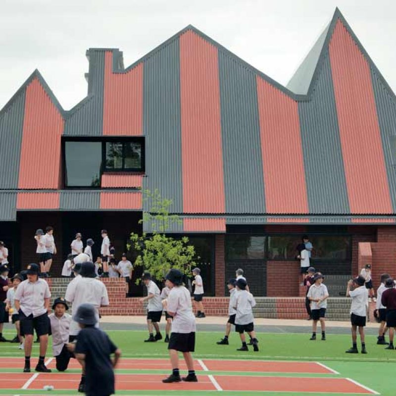 The SPANDEK® roof made from COLORBOND® steel in the colours Headland® and Monument® also nods to the home of the Essendon Football Club across the road, and creates a circus-marquee-meets-federation-grandstand aesthetic that is an ideal backdrop for a children’s playground.